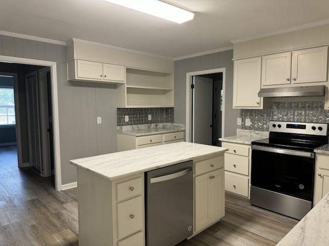 kitchen with dark wood-type flooring, ornamental molding, stainless steel appliances, and white cabinets