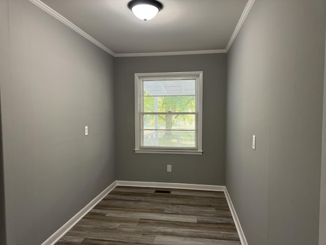 unfurnished room with ornamental molding and dark hardwood / wood-style floors