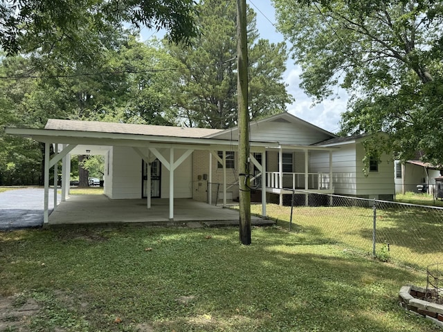 exterior space featuring a carport and a yard