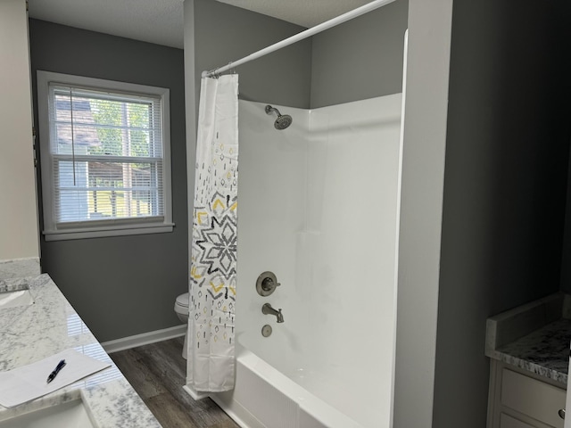 full bathroom featuring hardwood / wood-style flooring, shower / tub combo with curtain, vanity, and toilet