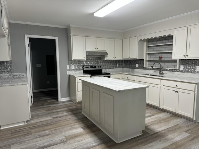 kitchen featuring sink, crown molding, stainless steel range with electric stovetop, a center island, and white cabinets