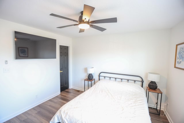 bedroom featuring ceiling fan and dark hardwood / wood-style flooring