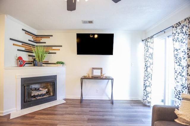 living room featuring ornamental molding, dark hardwood / wood-style floors, and ceiling fan