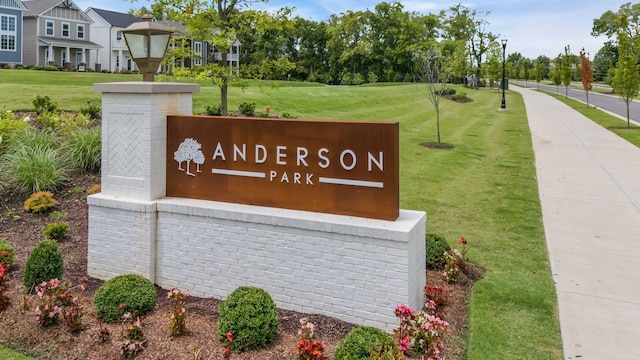 community / neighborhood sign with a lawn