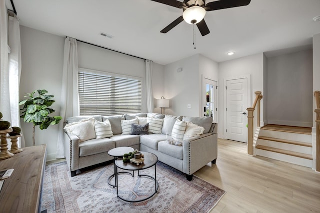 living room with ceiling fan and light wood-type flooring