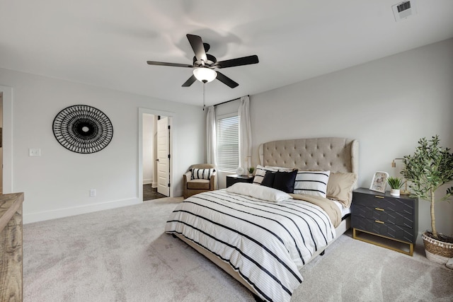 bedroom with ceiling fan, carpet floors, and ensuite bath