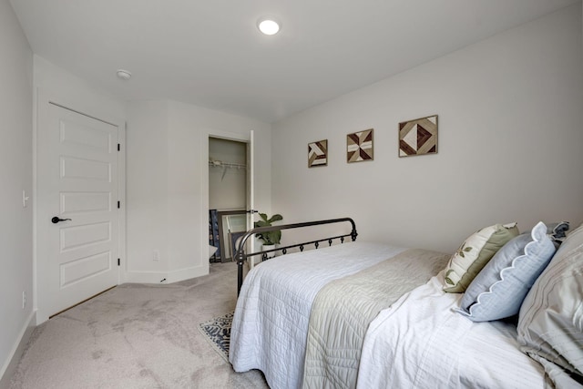 bedroom featuring a closet and light carpet