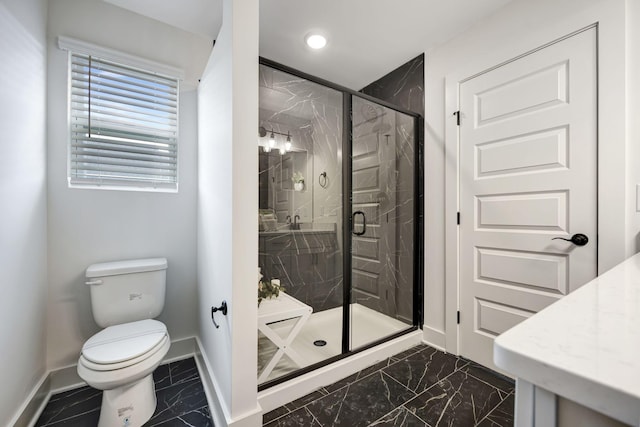 bathroom featuring a shower with door and toilet