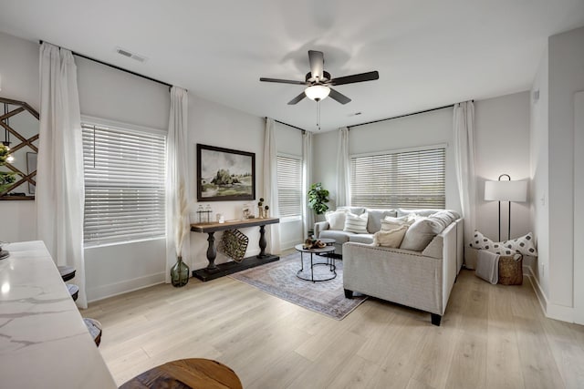 living room with ceiling fan and light hardwood / wood-style floors