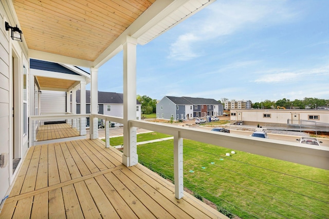 wooden deck featuring a lawn