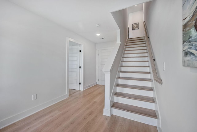 stairs with hardwood / wood-style flooring