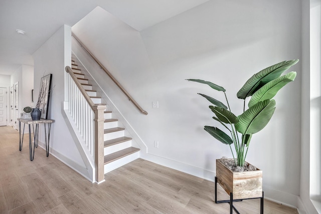 staircase featuring wood-type flooring