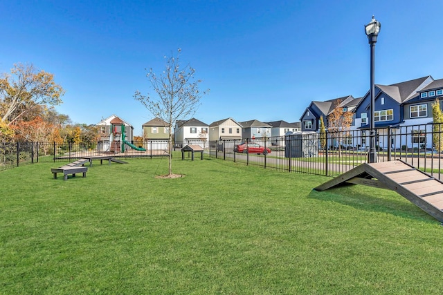 view of property's community featuring a playground and a yard