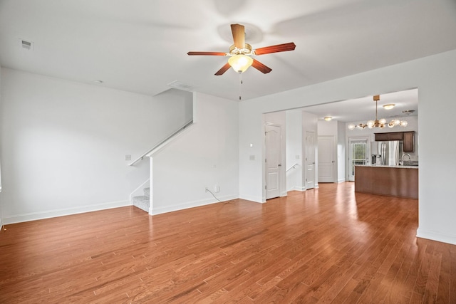 unfurnished living room featuring light hardwood / wood-style flooring and ceiling fan