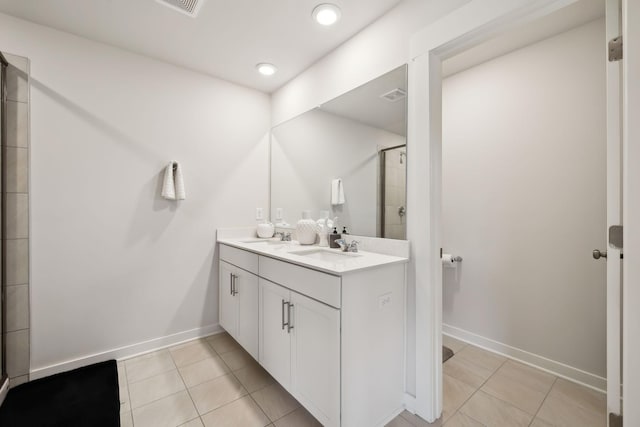 bathroom with vanity, a shower with shower door, and tile patterned flooring