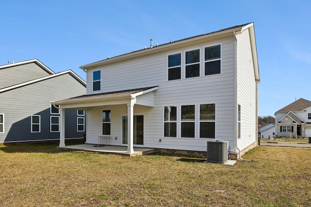 rear view of house with a lawn, a patio, and central air condition unit