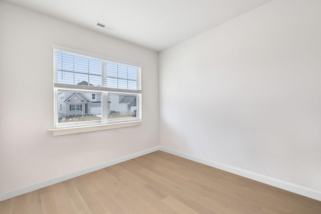 spare room featuring light hardwood / wood-style flooring