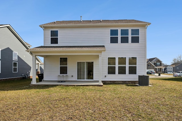 rear view of house featuring central AC, a lawn, and a patio