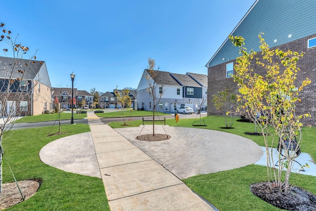 view of property's community with a yard and a patio area