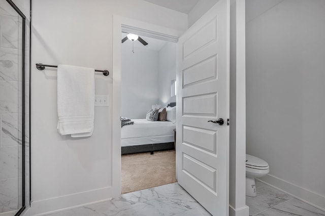 bathroom with a shower with door and toilet