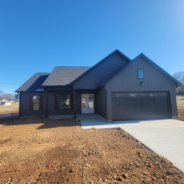 modern inspired farmhouse with a garage