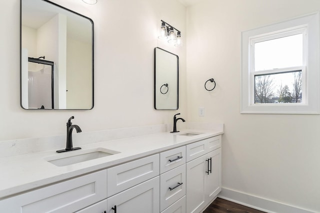 bathroom featuring hardwood / wood-style flooring and vanity