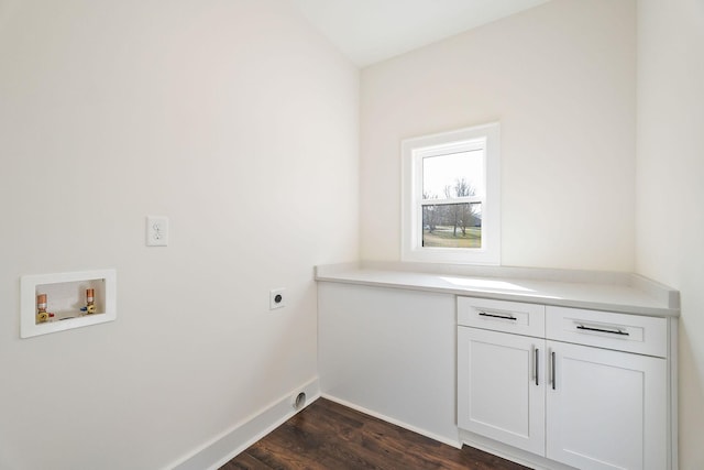 washroom with cabinets, hookup for an electric dryer, dark hardwood / wood-style flooring, and hookup for a washing machine