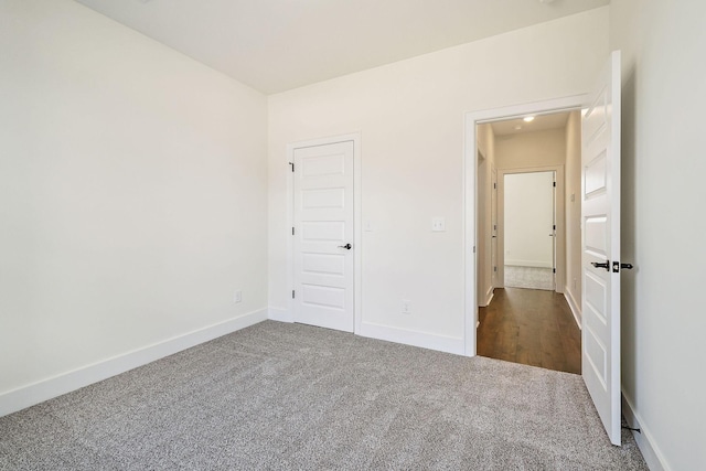 unfurnished bedroom featuring dark colored carpet