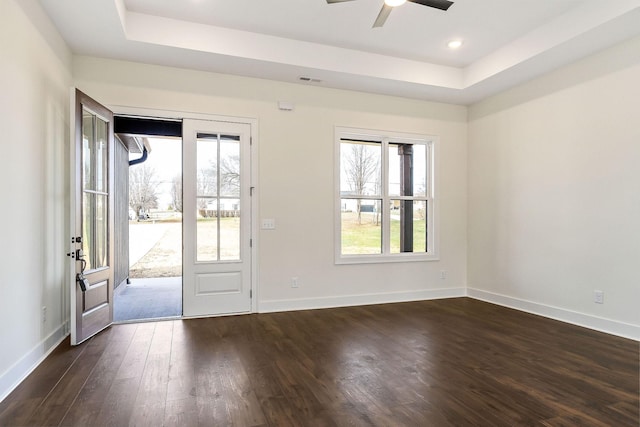 entryway with a raised ceiling, ceiling fan, and dark hardwood / wood-style flooring