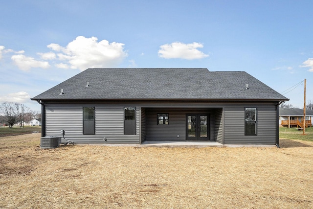 rear view of house featuring a yard, central air condition unit, and a patio area