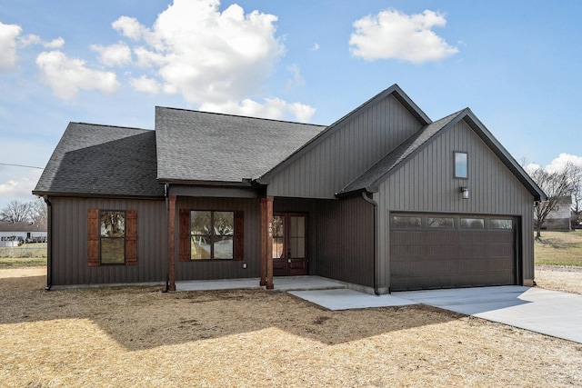 modern inspired farmhouse featuring a garage and a porch