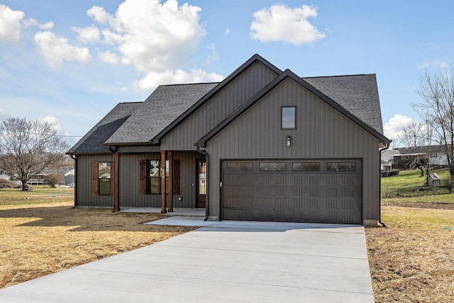 modern inspired farmhouse with a front lawn and a garage