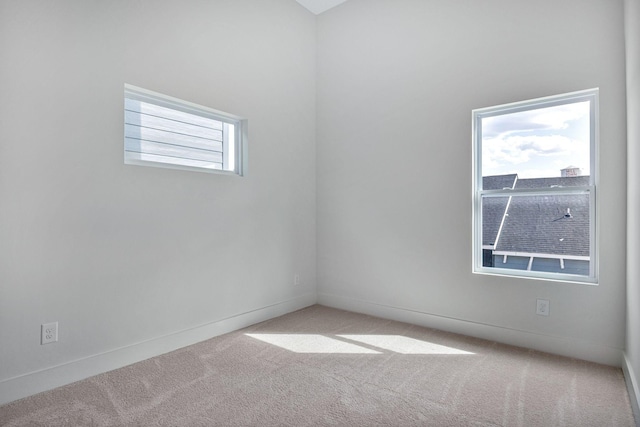 unfurnished room featuring light colored carpet