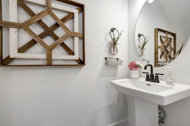 bathroom with lofted ceiling and sink