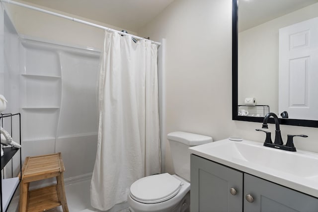 bathroom featuring vanity, toilet, and a shower with shower curtain