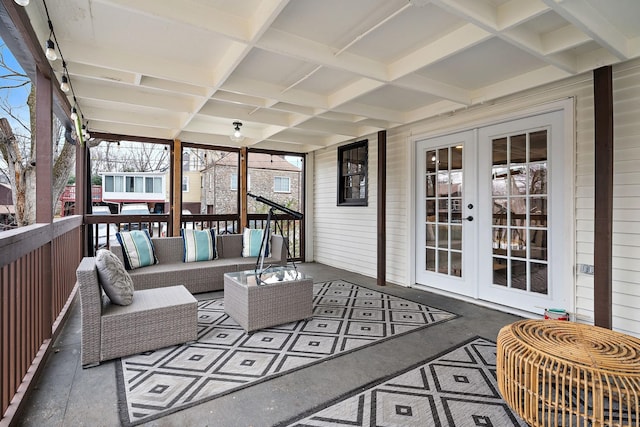 sunroom featuring beamed ceiling, coffered ceiling, and french doors