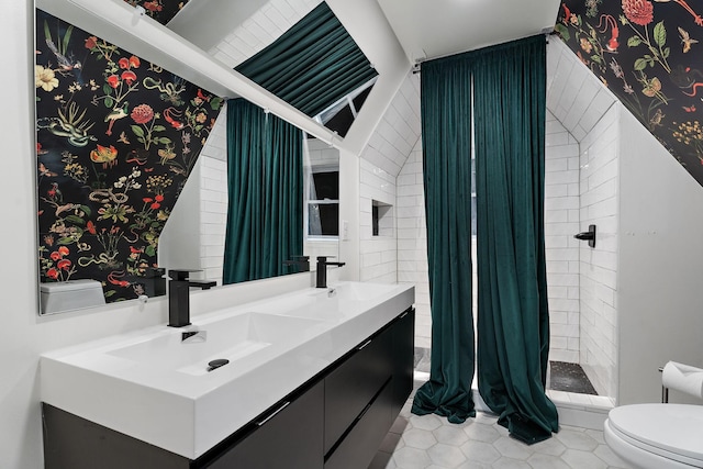 bathroom featuring tile patterned flooring, vanity, and toilet