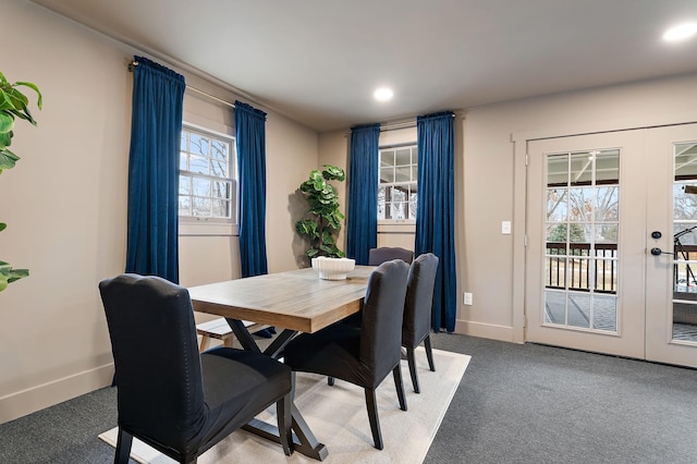 carpeted dining room with french doors