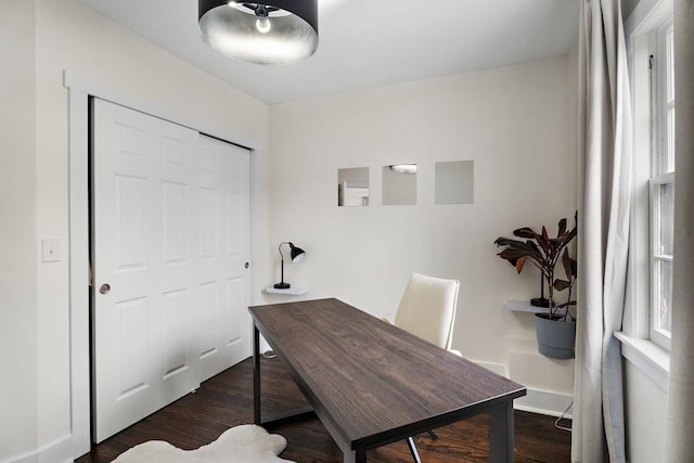 home office with dark hardwood / wood-style floors