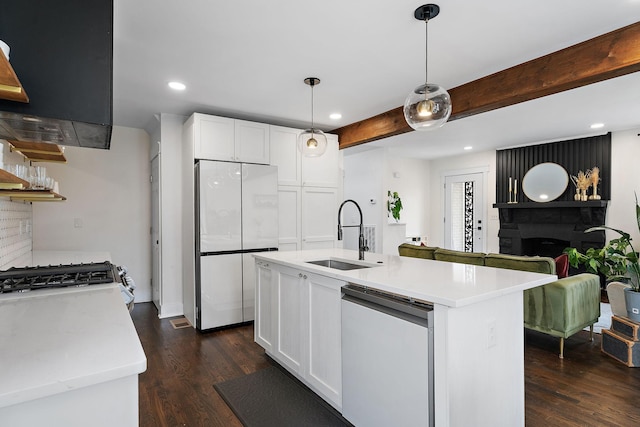 kitchen featuring sink, dishwasher, refrigerator, white cabinetry, and a center island with sink