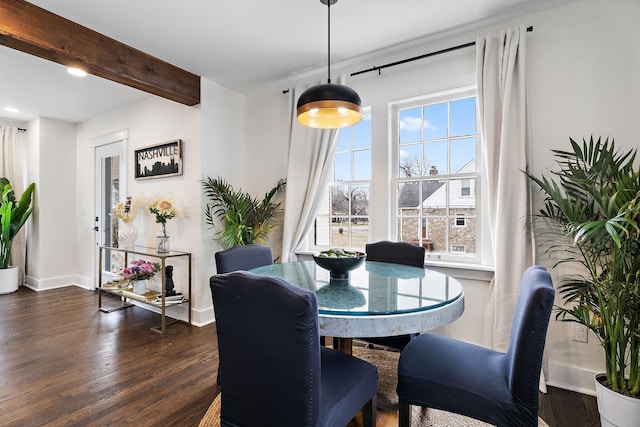 dining area featuring dark wood-type flooring and beam ceiling