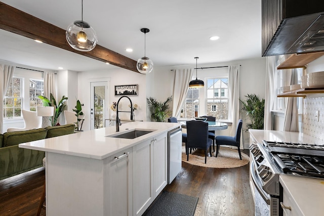 kitchen with sink, white cabinetry, decorative light fixtures, an island with sink, and stainless steel appliances