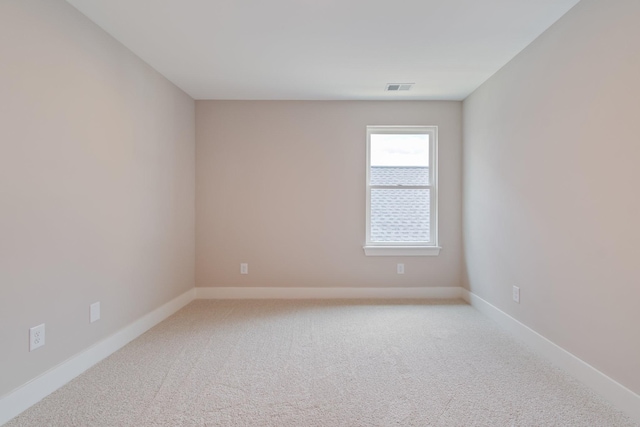 spare room with light carpet