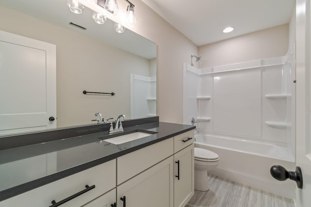 full bathroom featuring shower / tub combination, hardwood / wood-style floors, vanity, and toilet