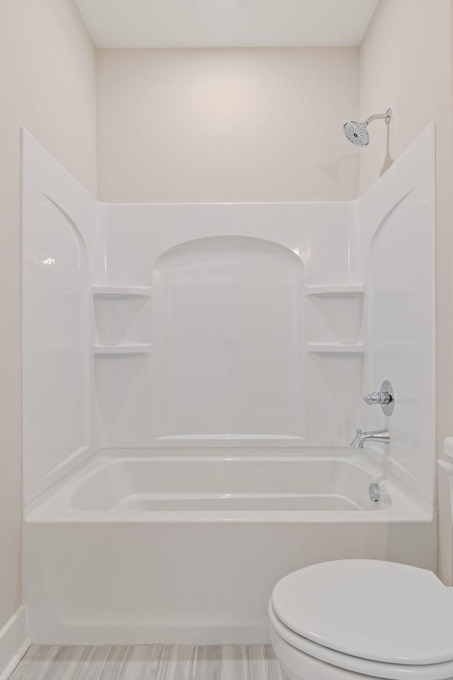 bathroom with toilet and shower / bath combination