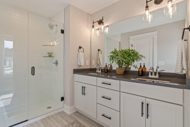 bathroom featuring vanity, a shower with door, and hardwood / wood-style floors