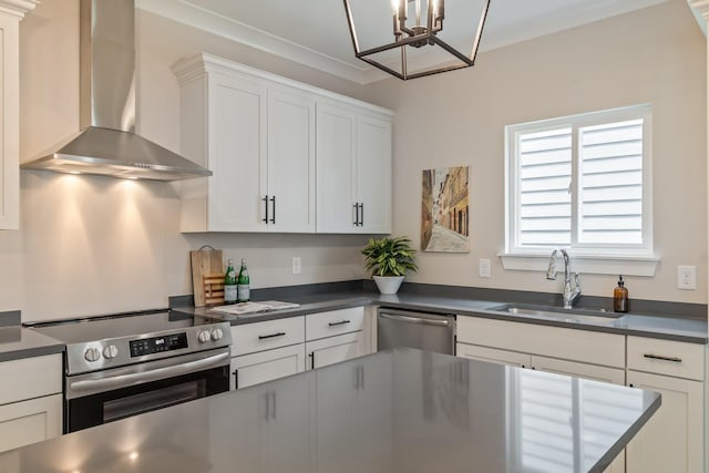 kitchen with white cabinets, stainless steel appliances, sink, and wall chimney range hood