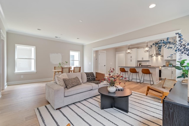 living room featuring light hardwood / wood-style flooring and ornamental molding