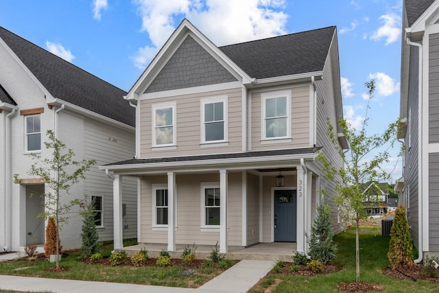 view of front of home featuring central AC, a front yard, and a porch