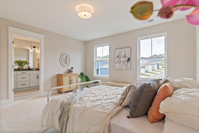 carpeted bedroom with connected bathroom